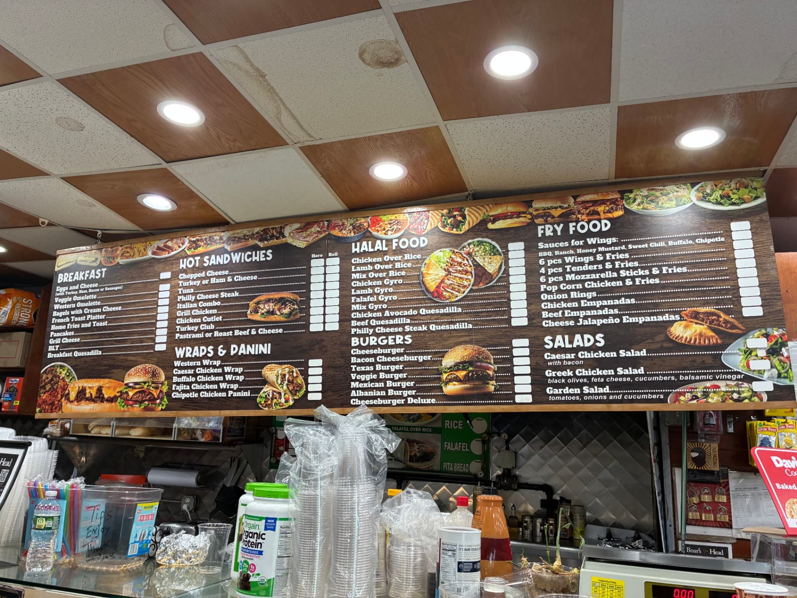 The menu board above the deli counter at The Famous Deli