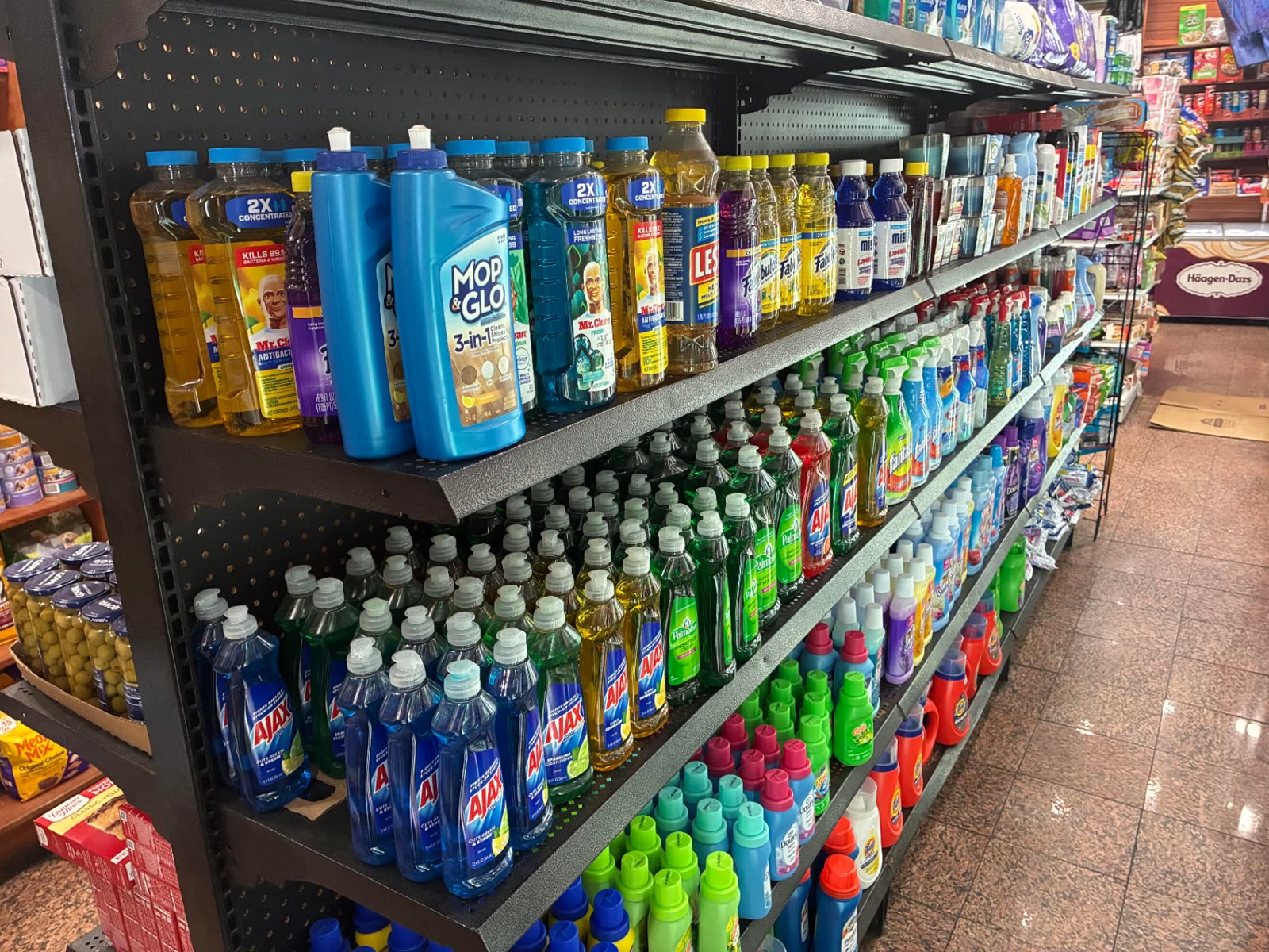 Aisle of cleaning products, dish soap and laundry detergent inside The Famous Deli